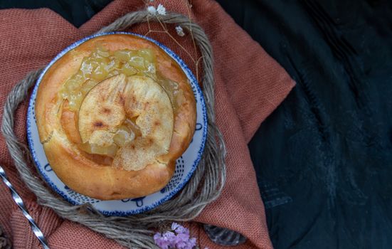 Traditional French sweet dessert : Apple Brioche on beautiful background. One piece,  Delicious seasonal breakfast. Top view, Selective focus.