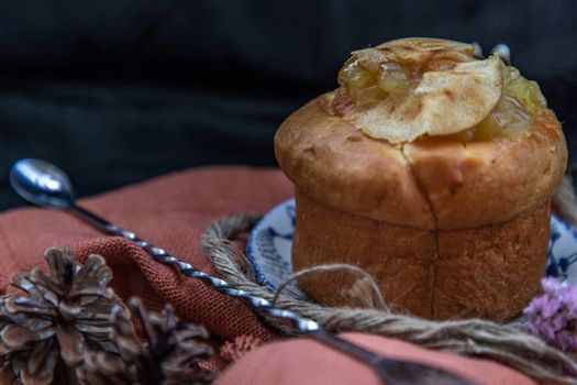 Traditional French sweet dessert : Apple Brioche on beautiful background. One piece. Delicious seasonal breakfast. Oblique view from the top, Selective focus.