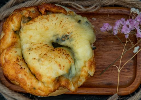 Traditional French sweet dessert : Spinach Brioche on the wooden tray. One piece, Delicious seasonal breakfast. Top view, Selective focus.