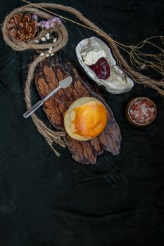 Traditional french sweet dessert : Scones on the wooden tray served with Homemade raspberry jam and Mascarpone cheese on Shell. Delicious seasonal breakfast. Selective focus.