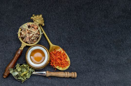 Wonderful Thai herbal tea with Dried lemongrass herb and pandanus and safflower on spoons with honey. Organic herbal, Selective focus, Copy space.