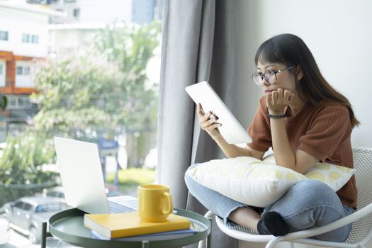 Teen girl using computer laptop to self study online at home. Online learning, e-learning, self study and online education concept.