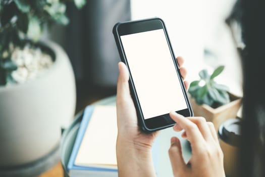 Close up of woman hand holding smart phone. Blank screen mockup for graphics display montage.