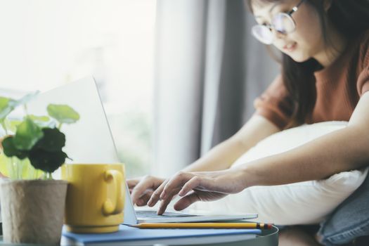 Teen girl using computer laptop to self learning online. Online learning, e-learning, self study and online education concept.