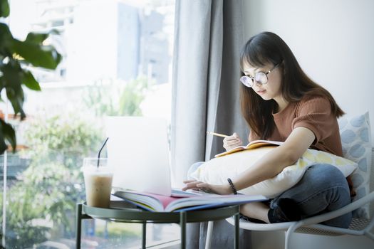 Teen girl using computer laptop to self learning online. Online learning, e-learning, self study and online education concept.