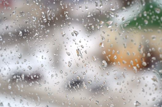 Drops of rain on the window, rainy day. Shallow DOF