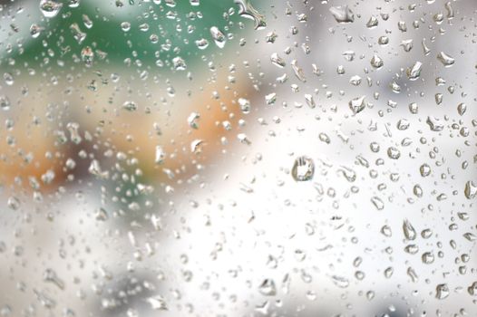 Drops of rain on the window, rainy day. Shallow DOF