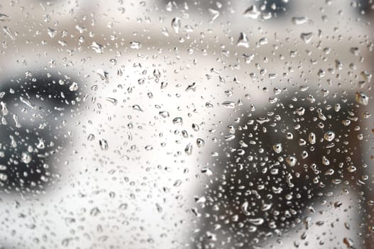 Drops of rain on the window, rainy day. Shallow DOF