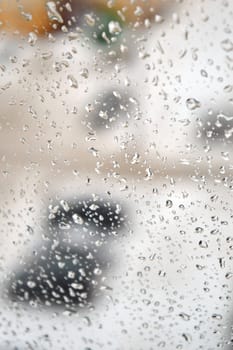 Drops of rain on the window, rainy day. Shallow DOF