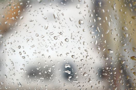 Drops of rain on the window, rainy day. Shallow DOF