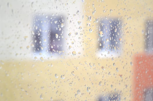 Drops of rain on the window, rainy day. Shallow DOF