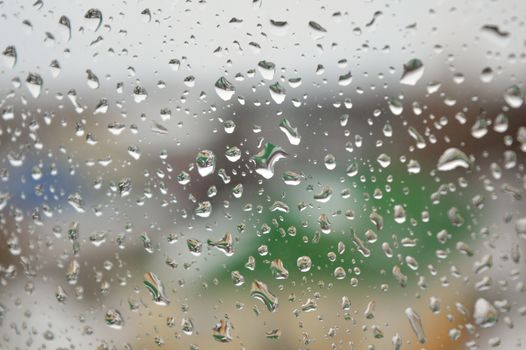 Drops of rain on the window, rainy day. Shallow DOF