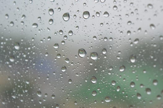 Drops of rain on the window, rainy day. Shallow DOF