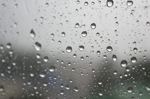 Drops of rain on the window, rainy day. Shallow DOF