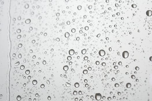 Drops of rain on the window, rainy day. Shallow DOF