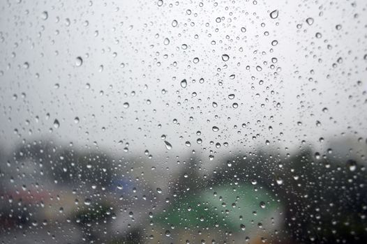 Drops of rain on the window, rainy day. Shallow DOF