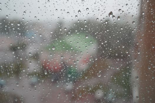 Drops of rain on the window, rainy day. Shallow DOF