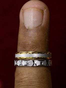 Wearing a round silver one ring and gold one