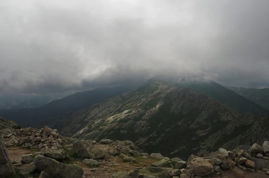 hight mountain view scenery with the storm clouds and fog and granite rock