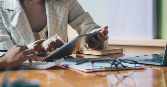 Business people meeting to discuss the situation on the market with tablet computer.