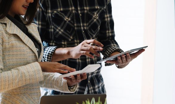 Business people meeting to discuss the situation on the market with tablet computer.