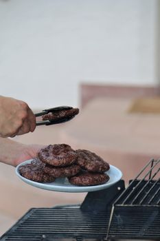 Burger on a plate over the grill