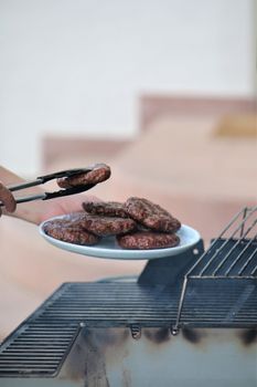 Burger on a plate over the grill