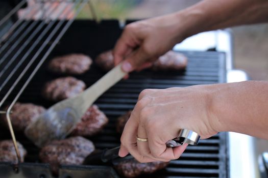 Several minced steaks on the grill