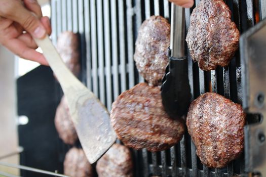 Several minced steaks on the grill