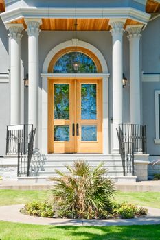A perfect neighbourhood. Entrance of luxury family house with doorsteps in front