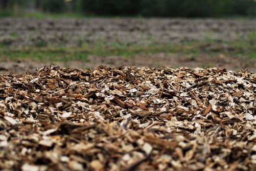 Wood chips in front of a plowed field