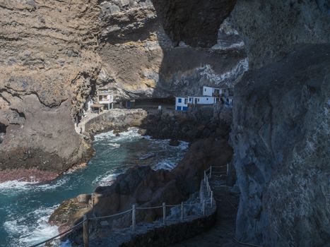 Cueva de Candelaria, Pirate cave Poris de Candelaria, small hidden fisherman village with white and blue houses, tourist attraction near Tijarafe, La Palma, Canary islands, Spain.