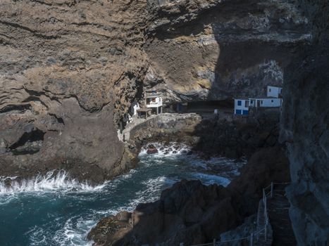Cueva de Candelaria, Pirate cave Poris de Candelaria, small hidden fisherman village with white and blue houses, tourist attraction near Tijarafe, La Palma, Canary islands, Spain.