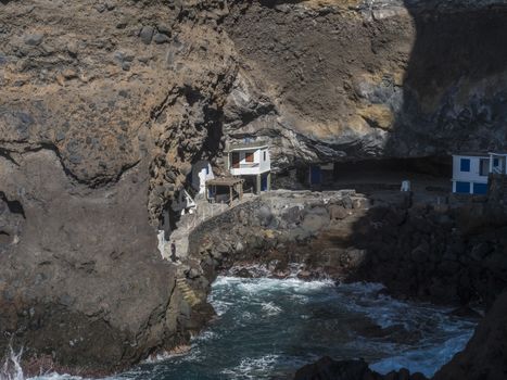 Cueva de Candelaria, Pirate cave Poris de Candelaria, small hidden fisherman village with white and blue houses, tourist attraction near Tijarafe, La Palma, Canary islands, Spain.