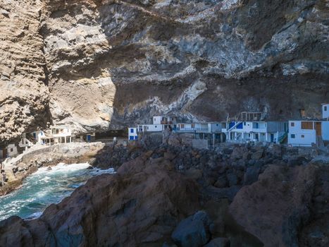Cueva de Candelaria, Pirate cave Poris de Candelaria, small hidden fisherman village with white and blue houses, tourist attraction near Tijarafe, La Palma, Canary islands, Spain.