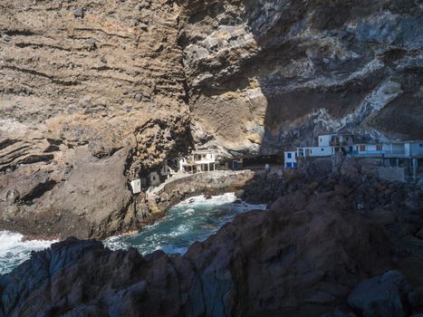 Cueva de Candelaria, Pirate cave Poris de Candelaria, small hidden fisherman village with white and blue houses, tourist attraction near Tijarafe, La Palma, Canary islands, Spain.