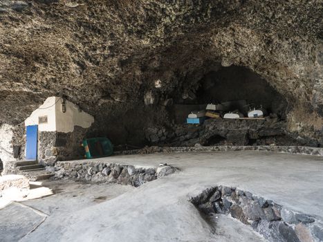 Stored wooden fishing boat at Cueva de Candelaria, Pirate cave Poris de Candelaria, small hidden fisherman village near Tijarafe, La Palma, Canary islands, Spain.