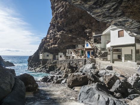 Cueva de Candelaria, Pirate cave Poris de Candelaria, small hidden fisherman village with white and blue houses, tourist attraction near Tijarafe, La Palma, Canary islands, Spain.