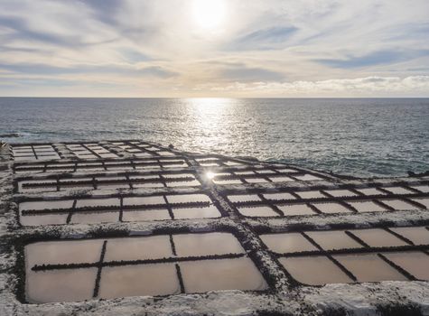 View of Fuencaliente salinas or saltworks and volcanic rock field at atlantic ocean sea shore and sun. La Palma, Canary Islands. Ocean, blue sky white clouds