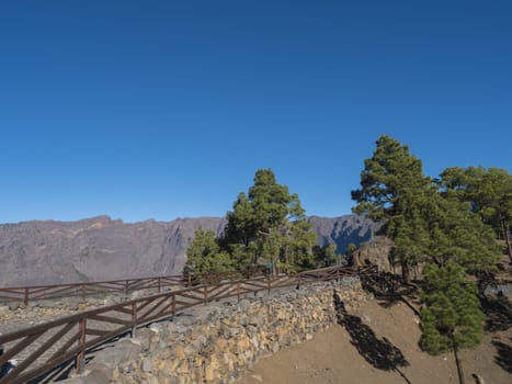 Volcanic landscape and lush pine tree forest, pinus canariensis view from Mirador de la Cumbrecita viewpoint at national park Caldera de Taburiente, volcanic crater in La Palma, Canary Islands, Spain.