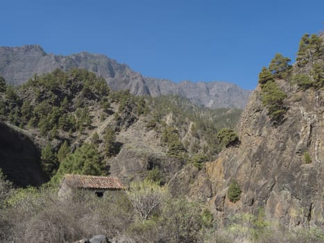 Old stone house at ravine of the Barranco de las Angustias canyon at hiking trail Caldera de Taburiente, La Palma, Canary Islands, Spain.