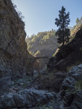 Old stone bridge at ravine of the Barranco de las Angustias canyon at hiking trail Caldera de Taburiente, La Palma, Canary Islands, Spain.