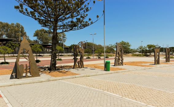 Parking lot at the Cape Town stadium with brown metal figures.