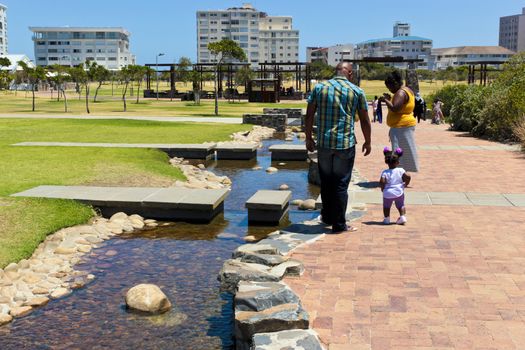 Green Point Park lake panorama with family in Cape Town, South Africa.