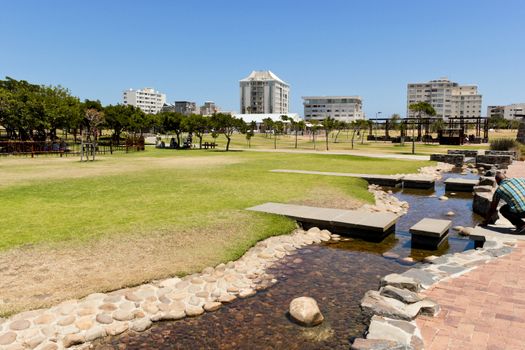 Green Point Park lake and hotels panorama in Cape Town, South Africa.