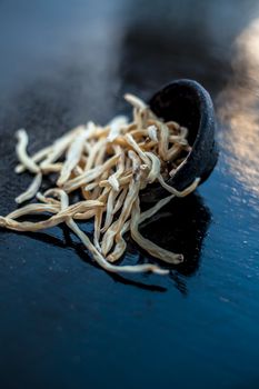 Popular Indian &amp; Asian ayurvedic organic herb musli Safed Moosli/ Shaqaqule/ Dholi Musli/ Khiruva/ Shedheveli/ Swetha Musli/ Taniravi Thang/ in a clay bowl on wooden surface.