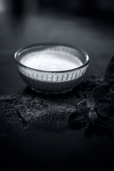 Ayurvedic herb brahmi or Waterhyssop with its beneficial paste ina glass bowl along with its powder on wooden surface.
