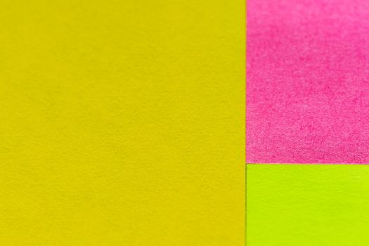 Yellow, green and pink paper pattern arranged in the background