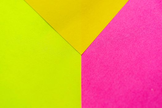 Yellow, green and pink paper pattern arranged in the background