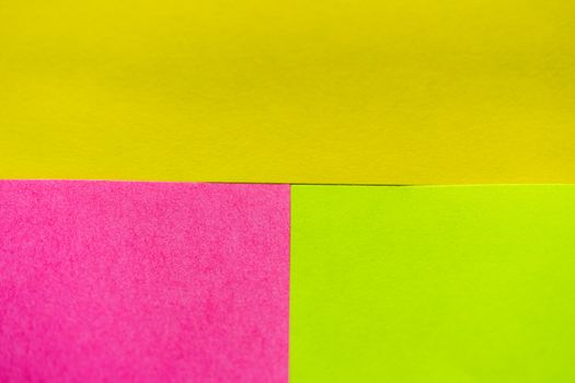 Yellow, green and pink paper pattern arranged in the background